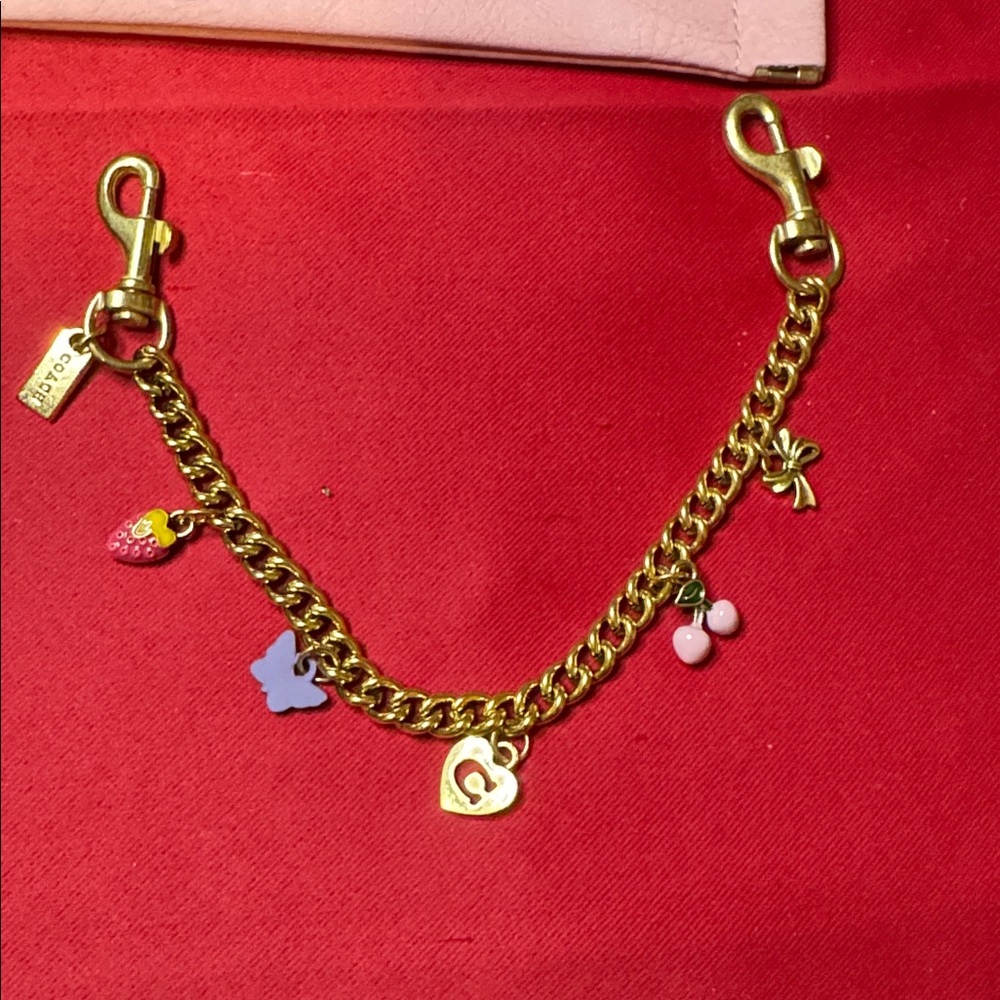 Coach style 12” Gold Bracelet with Pink and Purple bag Charms